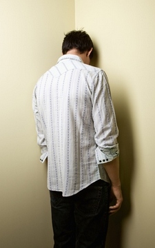 standing in the corner, awaiting his spanking